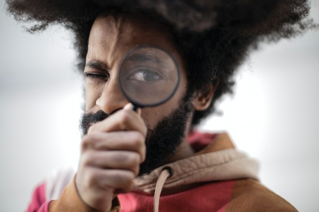 Man using magnifying glass