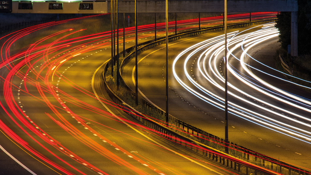 Slow exposure of the bend of road at night