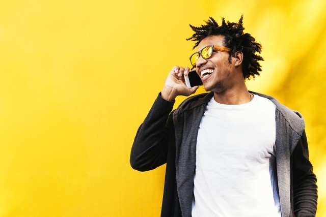 Portrait of handsome afro man using his mobile.