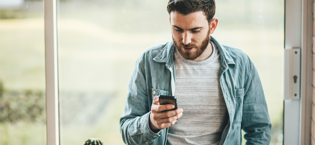 Image of a man holding a phone